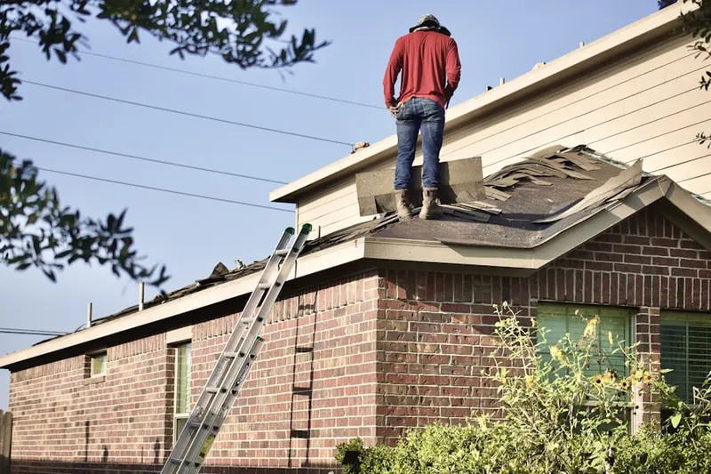 Professional roofer working on a residential roof in Hadley Farms